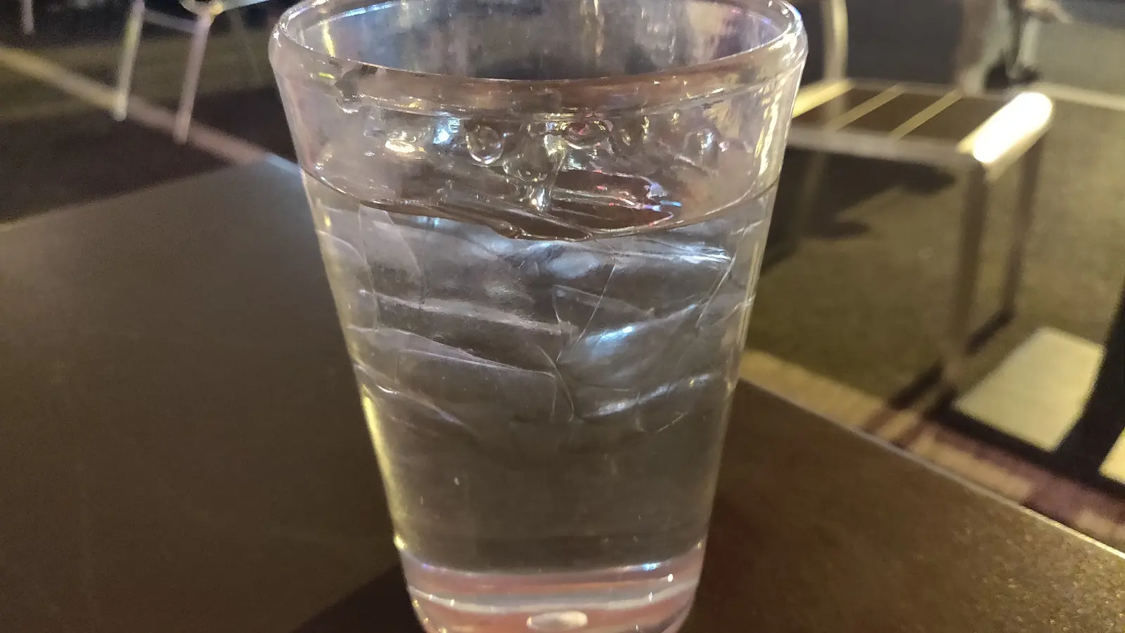 A glass of drinking water on a table
