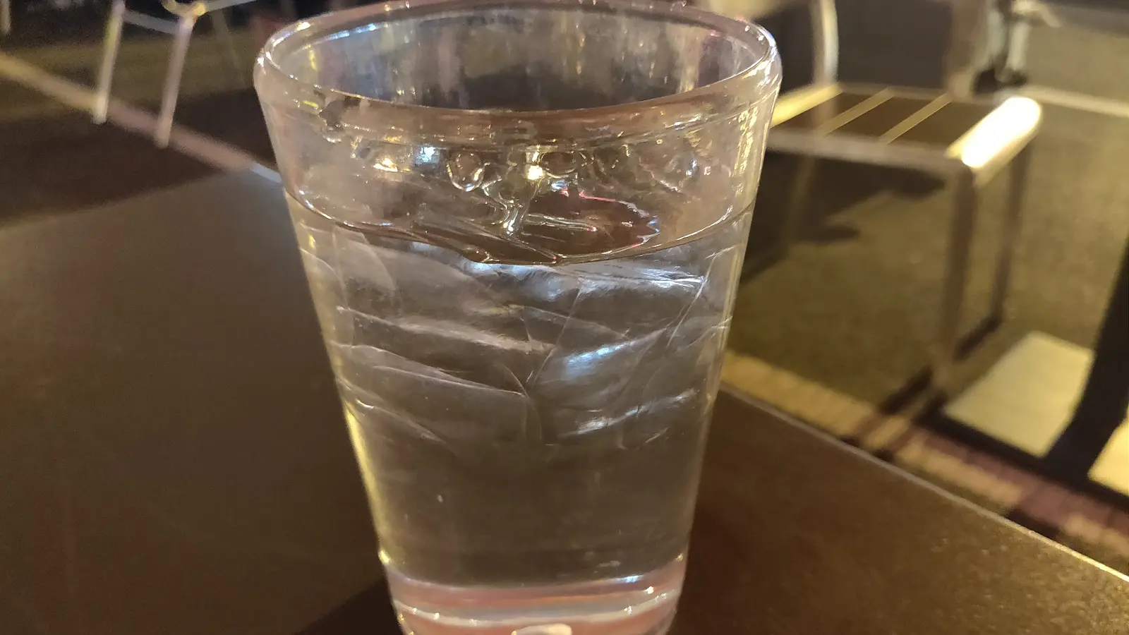 A glass of drinking water, seen from a low angle